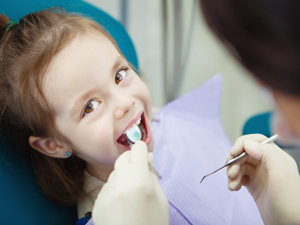 Child being examined by the dentist