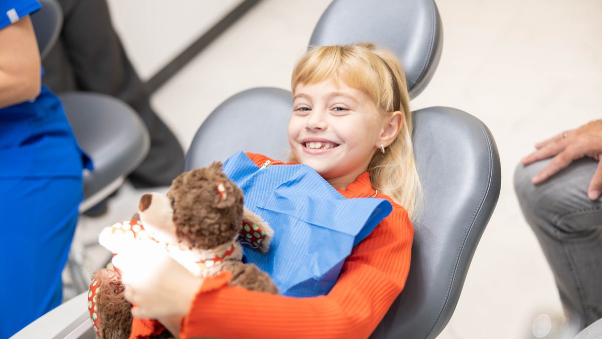 Pediatric dental patient sitting in the dental office