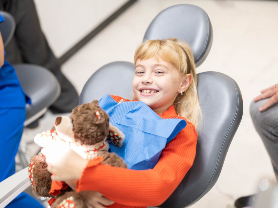 Pediatric dental patient sitting in the dental office